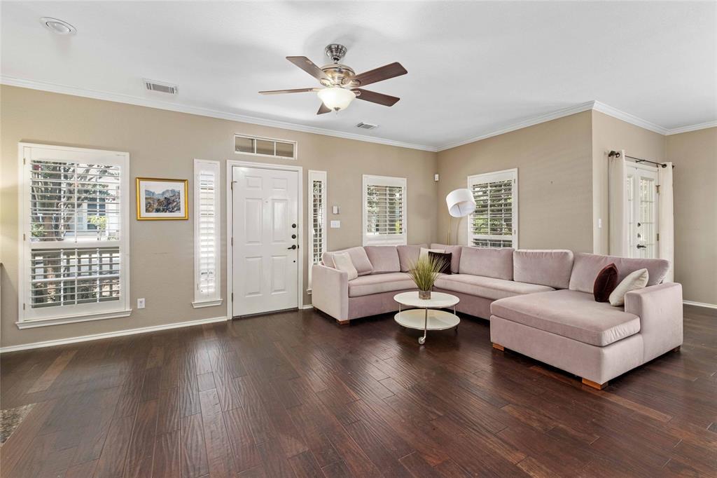 2730 Kinney Oaks Court Austin, TX 78704 - Photo 4 of 32 Step into this bright, inviting living room featuring gleaming hardwood floors, classic crown molding, and an open, airy feel.