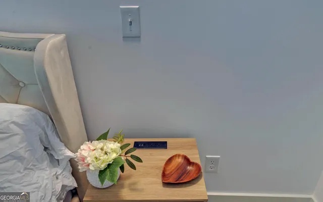 a spacious bedroom with a bed and a chandelier