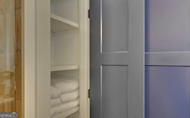 a view of walk in closet with empty racks