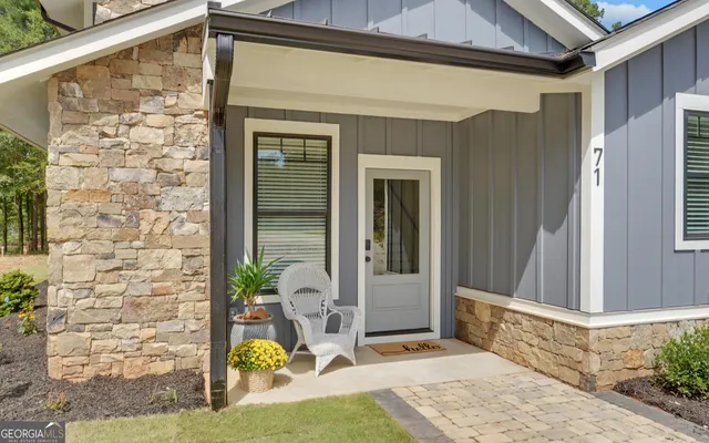 a view of a patio with couches chairs and a small yard