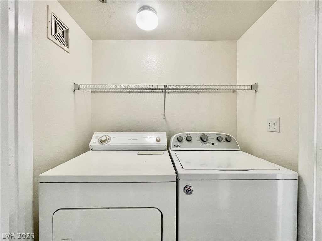 555 East Silverado Ranch Boulevard, Unit 1014 Las Vegas, NV 89183 - Photo 12 of 18 This dedicated laundry space features convenient appliances and practical shelving for storage.