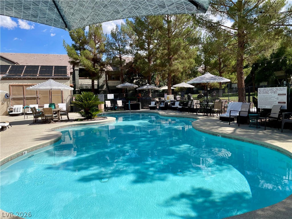 555 East Silverado Ranch Boulevard, Unit 1014 Las Vegas, NV 89183 - Photo 17 of 18 An inviting pool area offers a refreshing oasis for relaxation and leisure.