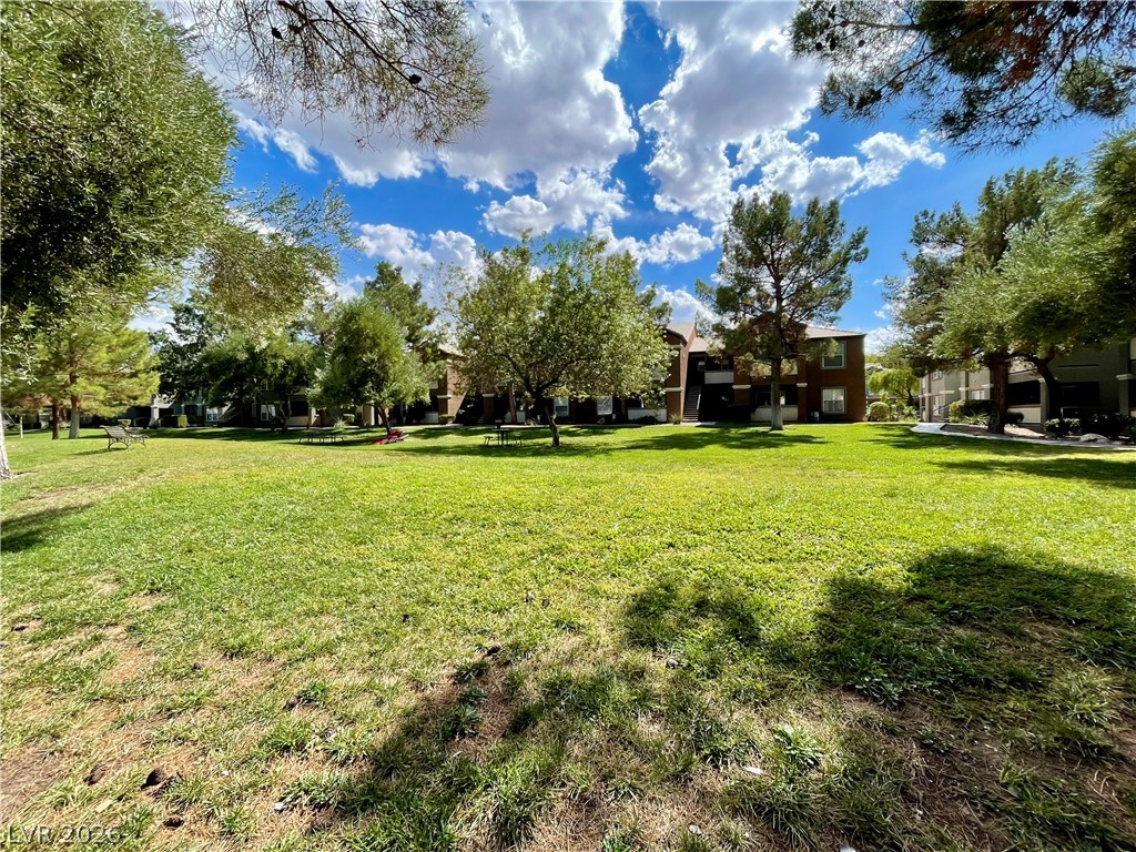 555 East Silverado Ranch Boulevard, Unit 1014 Las Vegas, NV 89183 - Photo 18 of 18 Lush green space offers serene outdoor living with ample room for leisure activities.