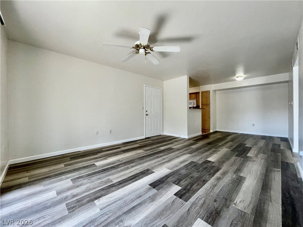 555 East Silverado Ranch Boulevard, Unit 1014 Las Vegas, NV 89183 - Photo 4 of 18 This versatile open-concept space features resilient plank flooring and essential lighting, perfect for any lifestyle.