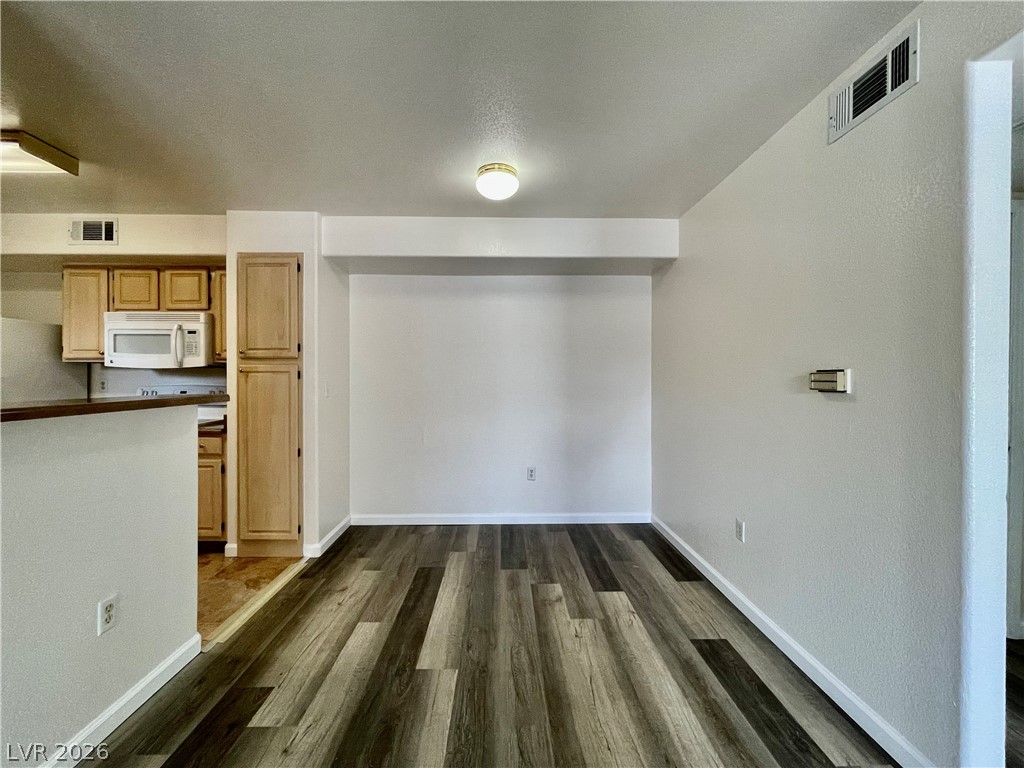 555 East Silverado Ranch Boulevard, Unit 1014 Las Vegas, NV 89183 - Photo 5 of 18 This versatile space flows into the kitchen, offering an adaptable area for dining or living.