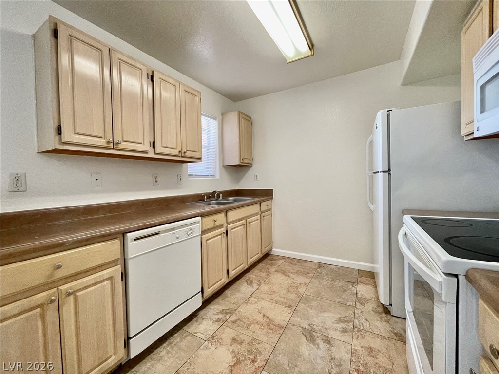 555 East Silverado Ranch Boulevard, Unit 1014 Las Vegas, NV 89183 - Photo 7 of 18 This functional kitchen features ample cabinetry and essential appliances for daily living.