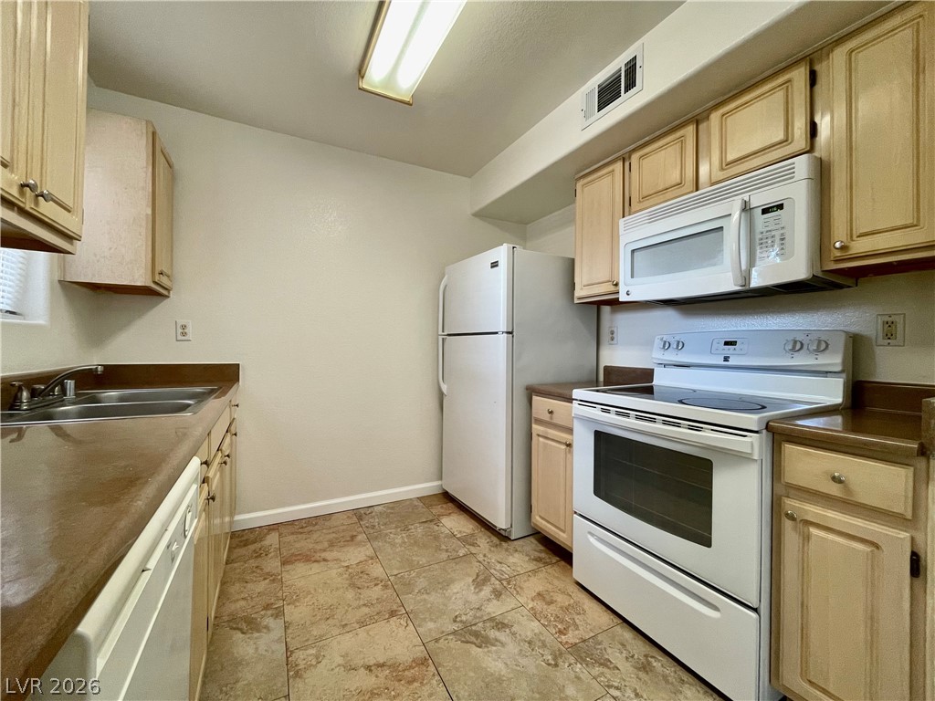 555 East Silverado Ranch Boulevard, Unit 1014 Las Vegas, NV 89183 - Photo 8 of 18 This kitchen offers practical amenities, ideal for everyday living.