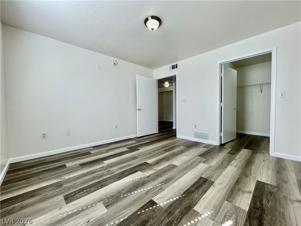 555 East Silverado Ranch Boulevard, Unit 1014 Las Vegas, NV 89183 - Photo 10 of 18 This spacious bedroom offers ample natural light and a clean, inviting atmosphere.