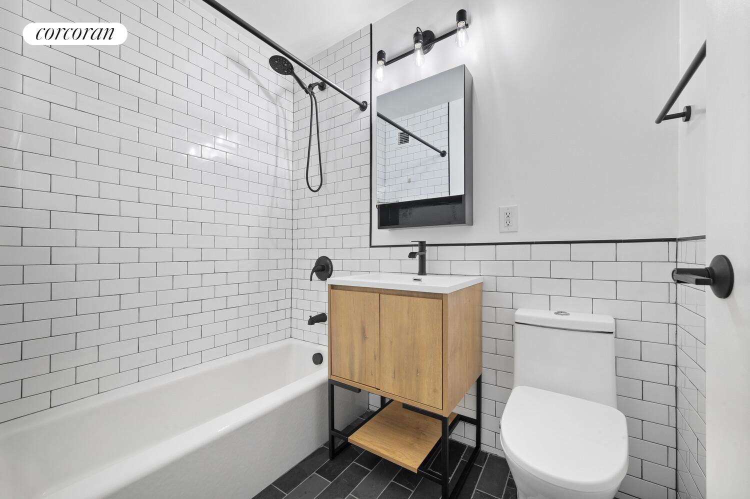 618 Washington Street, Unit GA Manhattan, NY 10014 - Photo 9 of 14 a bathroom with a sink a toilet and bathtub