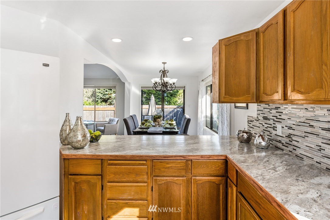 5405 156th Street Southwest Edmonds, WA 98026 - Photo 11 of 27 a kitchen with sink a window and cabinets