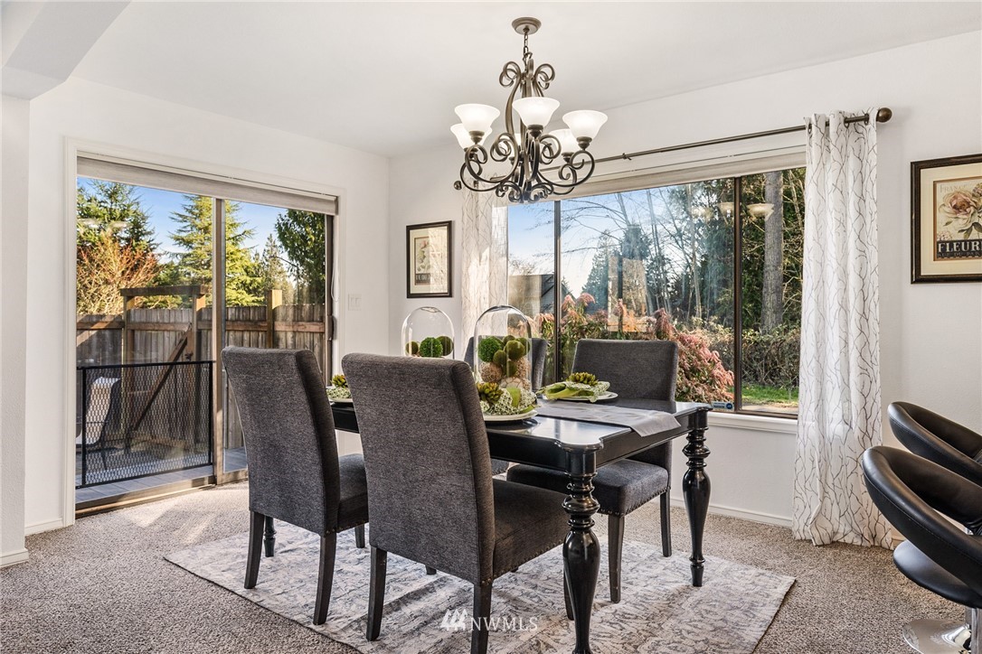 5405 156th Street Southwest Edmonds, WA 98026 - Photo 13 of 27 a view of a dining room with furniture a chandelier and window
