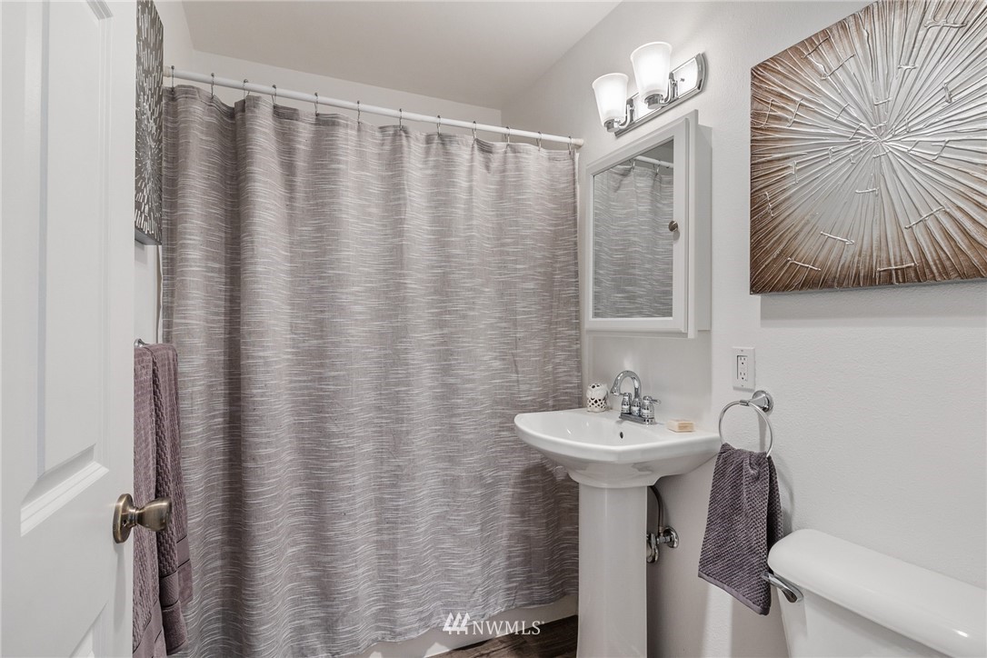 5405 156th Street Southwest Edmonds, WA 98026 - Photo 17 of 27 a bathroom with a sink mirror and a toilet