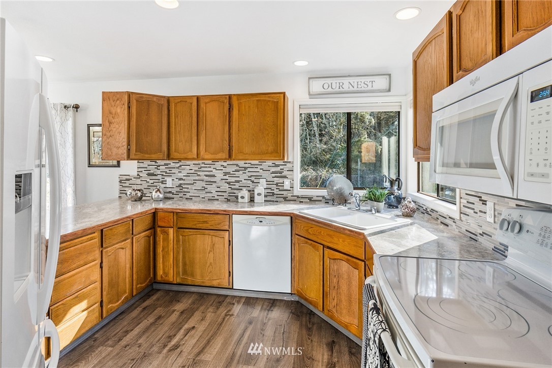 5405 156th Street Southwest Edmonds, WA 98026 - Photo 10 of 27 a kitchen with stainless steel appliances granite countertop a sink stove and cabinets