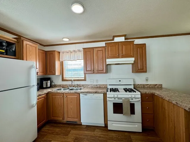 a kitchen with a stove a sink and a refrigerator