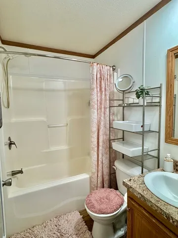 a bathroom with a granite countertop sink a toilet and a bathtub