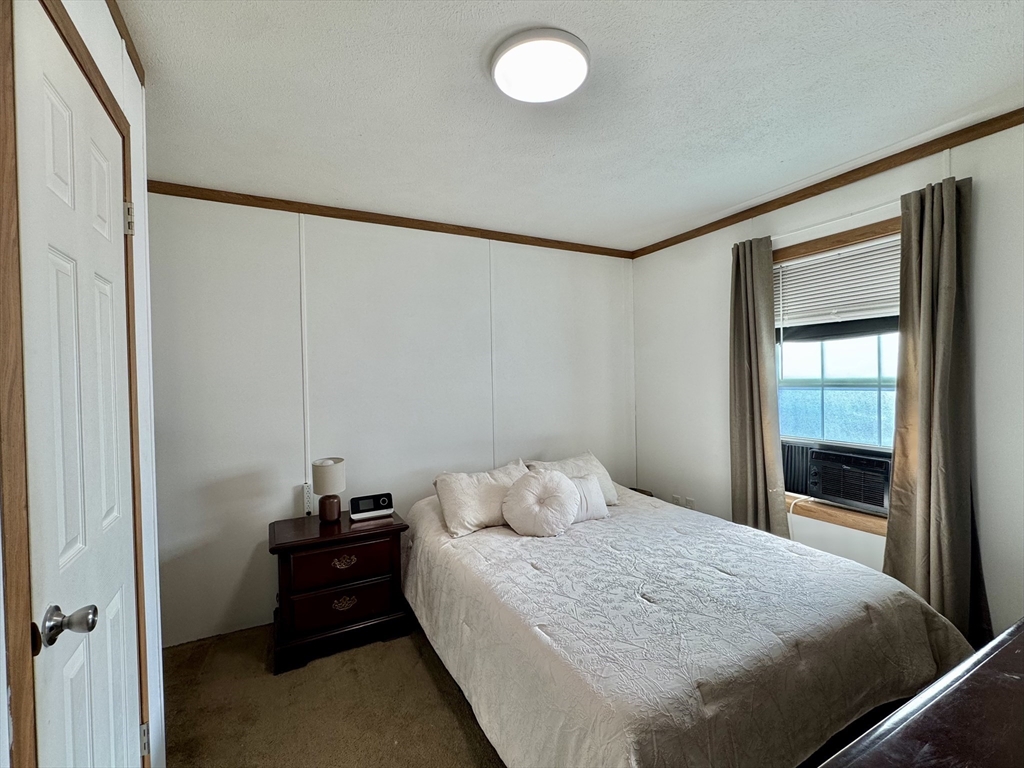 268 Palmer Road, Unit 2 Monson, MA 01057 - Photo 6 of 9 a bedroom with a bed and a window