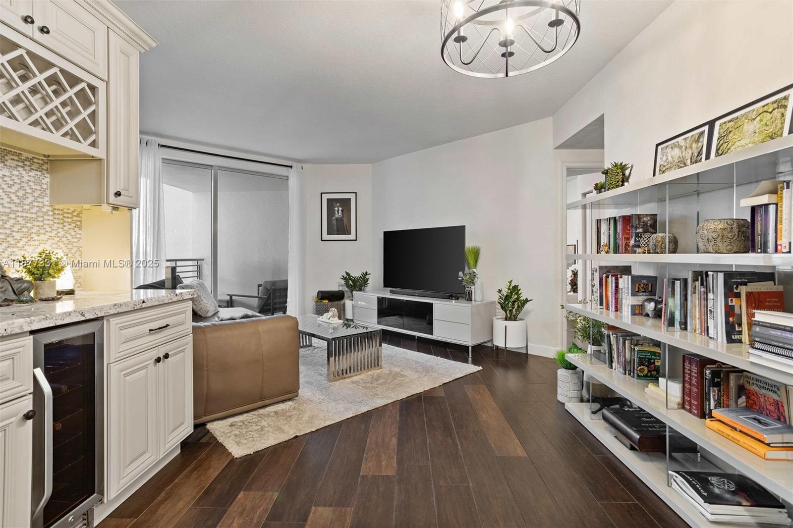 a living room with furniture a flat screen tv and a book shelf