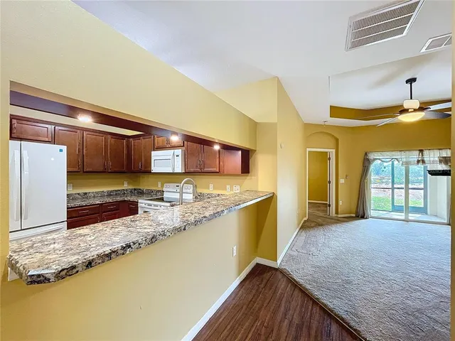 a view of a kitchen counter top space and wooden floor