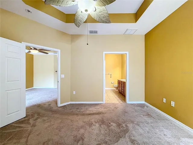 a bathroom with a granite countertop sink a light fixture and a mirror