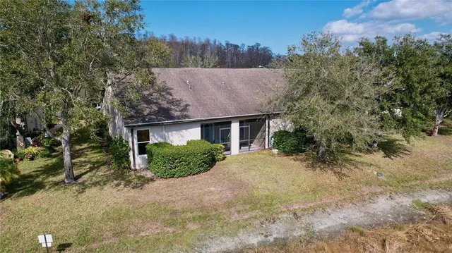 a view of a patio with chairs and a small yard