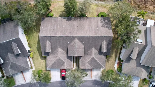 an aerial view of a house with garden space and car parked