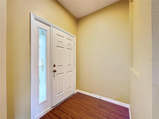 a view of a hallway with wooden floor