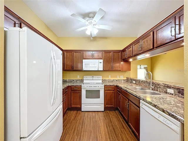 a kitchen with stainless steel appliances granite countertop stove a sink and refrigerator