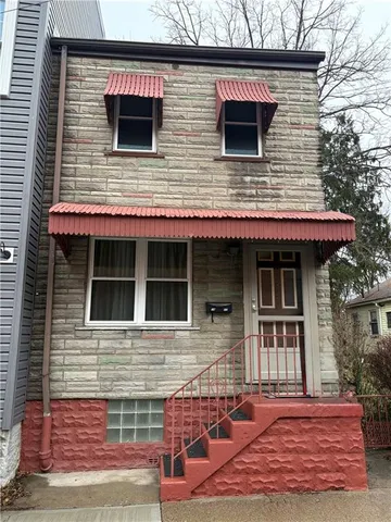 a view of a house with a door and wooden floor