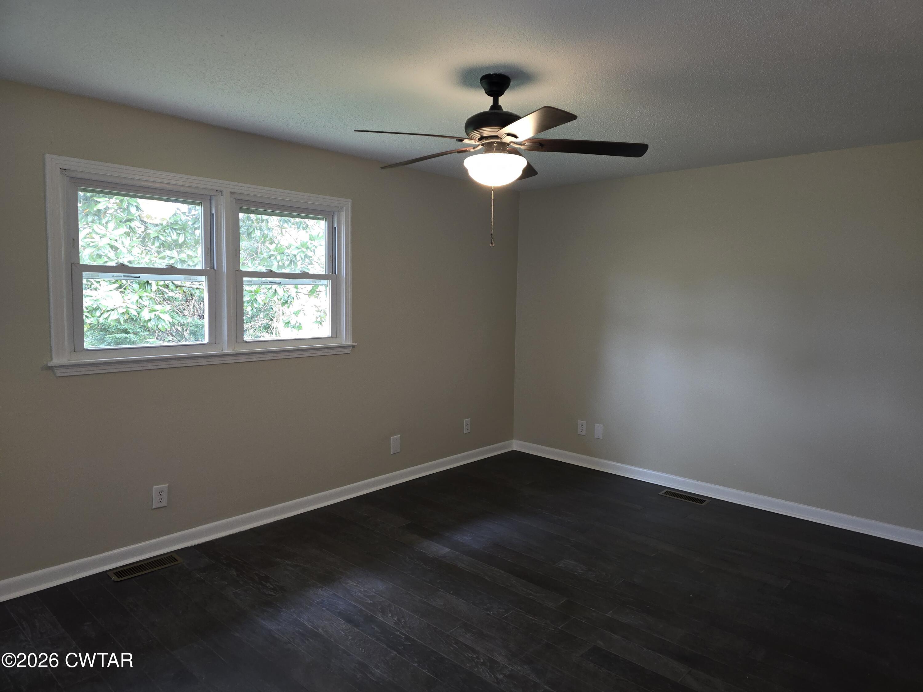 49 Brenda Lane Jackson, TN 38301 - Photo 18 of 23 a view of an empty room with wooden floor and a window