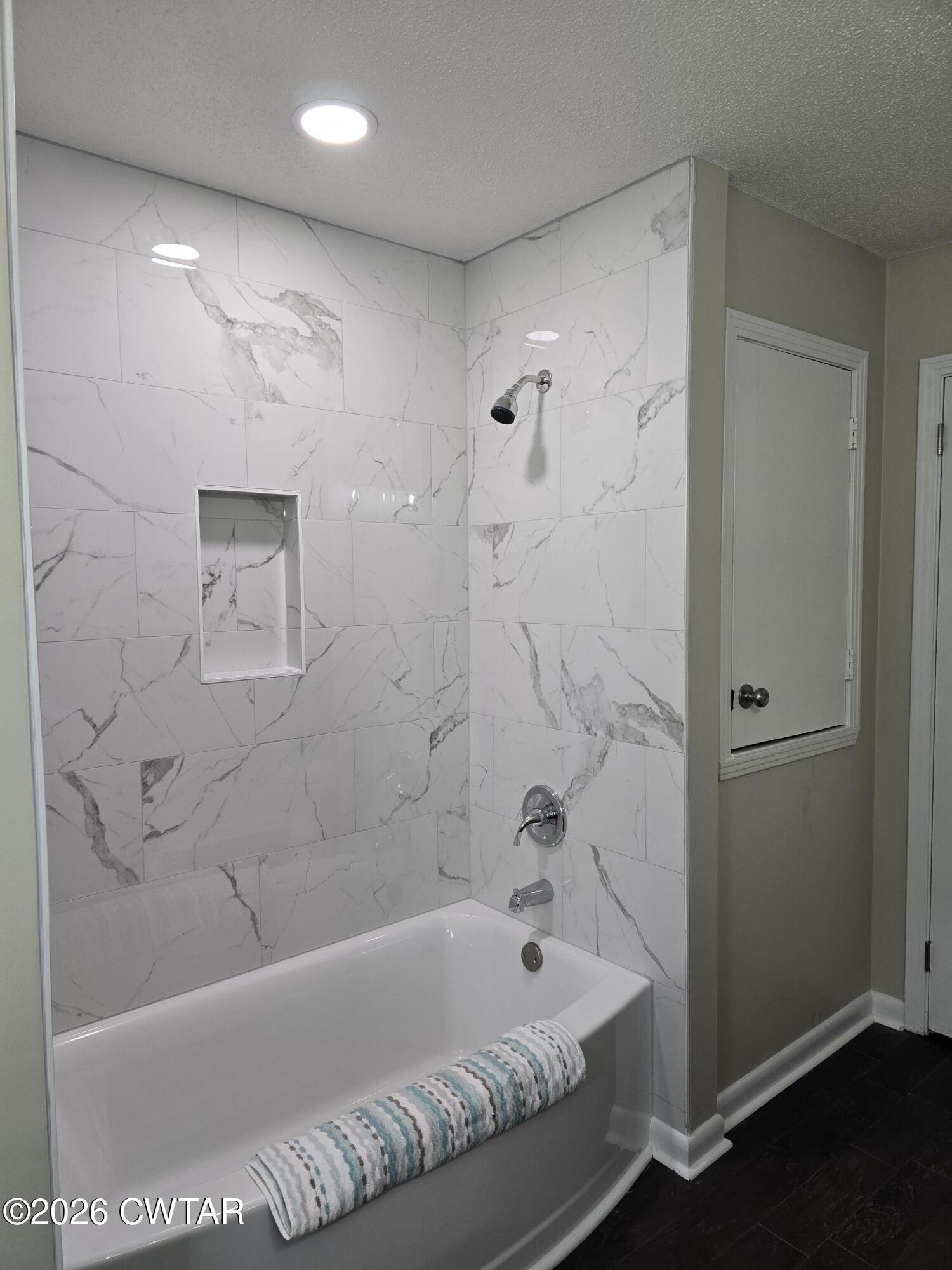 49 Brenda Lane Jackson, TN 38301 - Photo 20 of 23 a bathroom with a bathtub and a shower