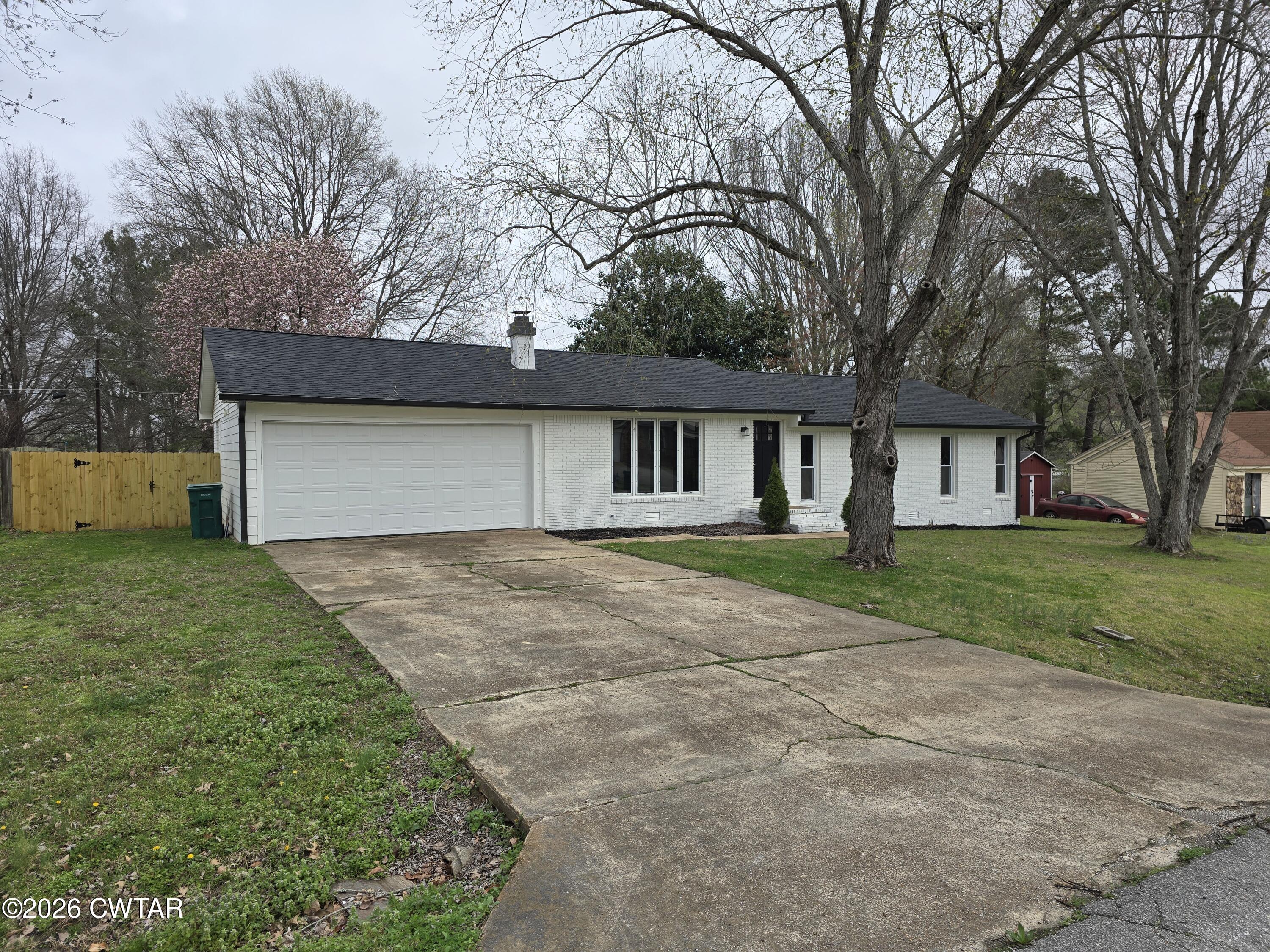 49 Brenda Lane Jackson, TN 38301 - Photo 4 of 23 a front view of a house with a yard and garage