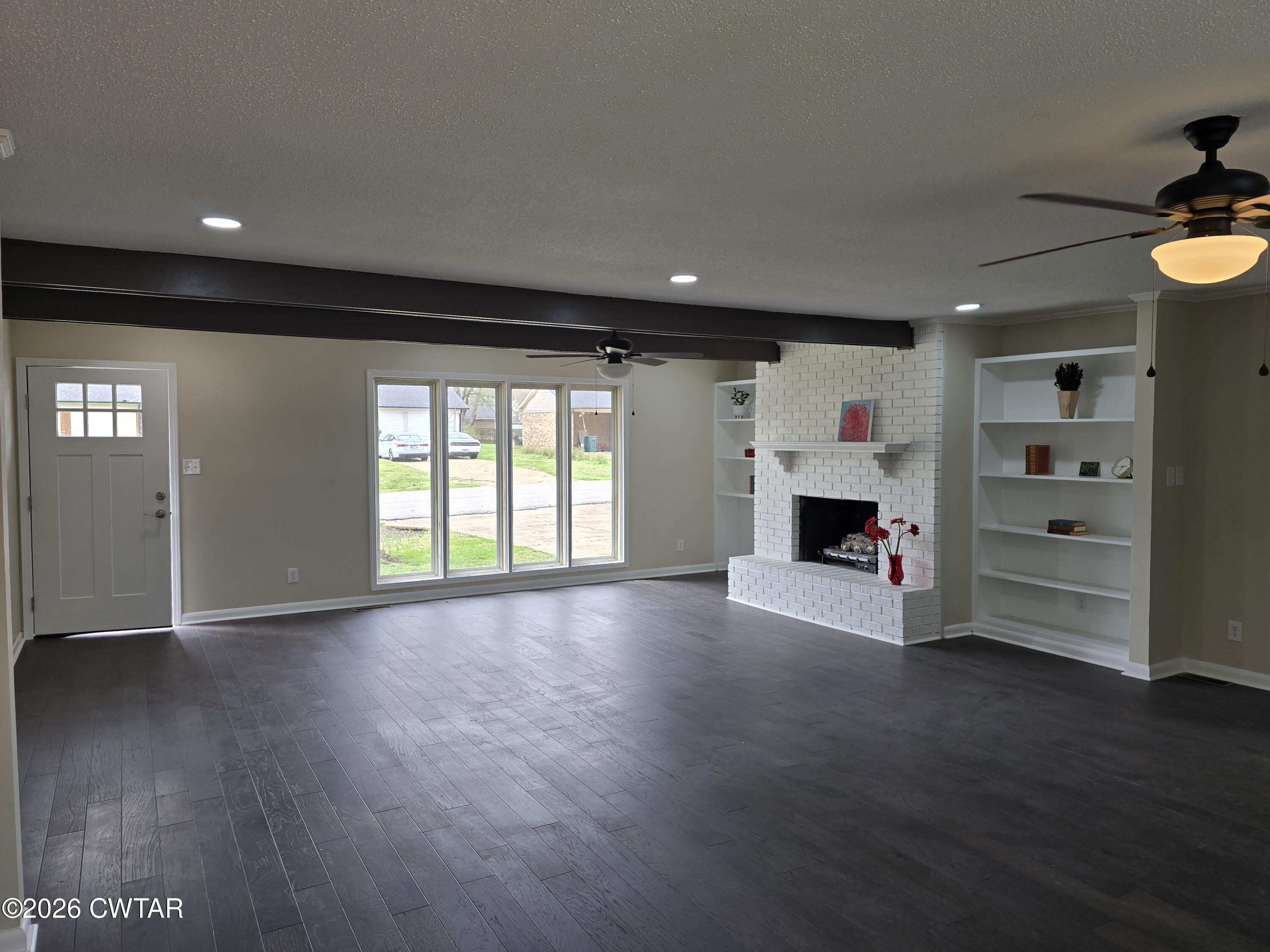 49 Brenda Lane Jackson, TN 38301 - Photo 7 of 23 a view of empty room with a fireplace and wooden floor