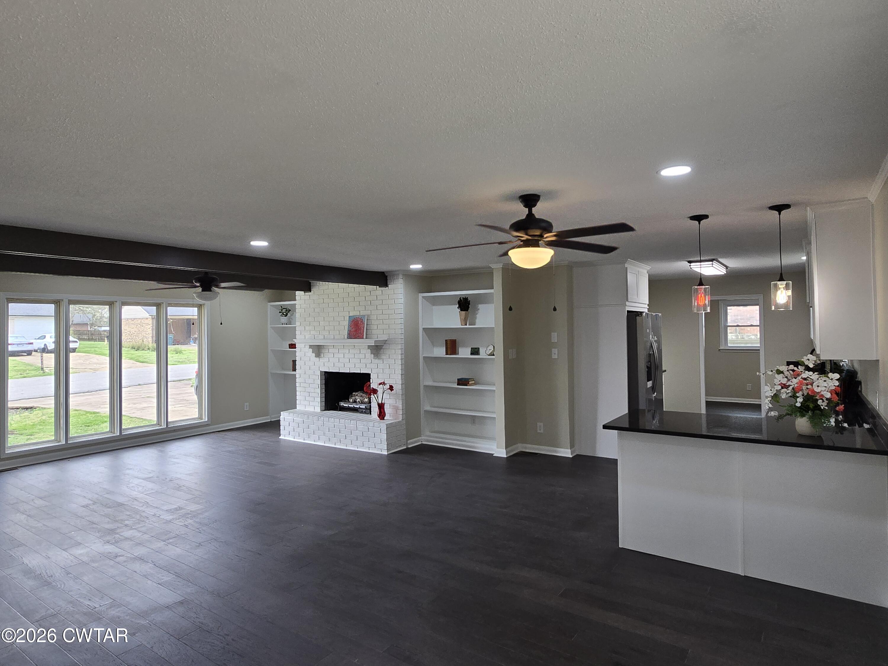 49 Brenda Lane Jackson, TN 38301 - Photo 8 of 23 an empty room with windows and fireplace