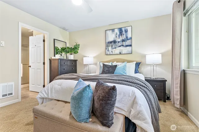 a bedroom with a bed and a painting on the wall