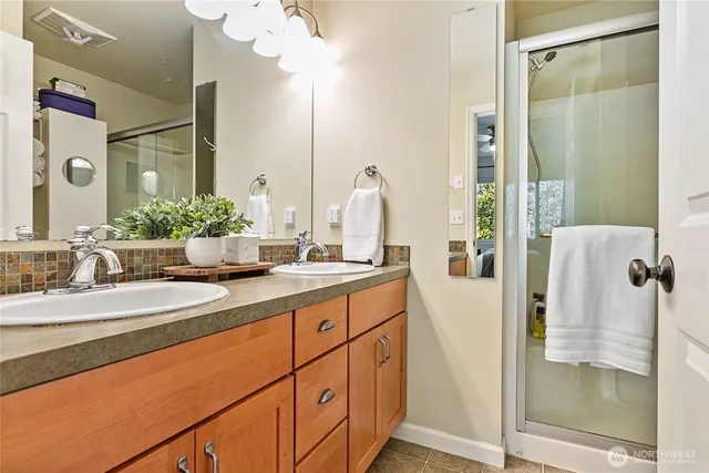 a bathroom with a double vanity sink and mirror