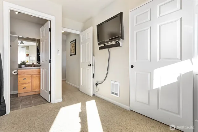 a view of a livingroom with wooden floor and a flat screen tv