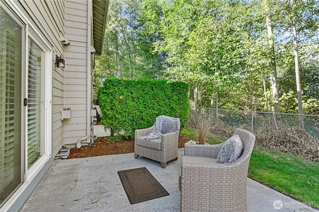 a view of a patio with couches chairs and a yard