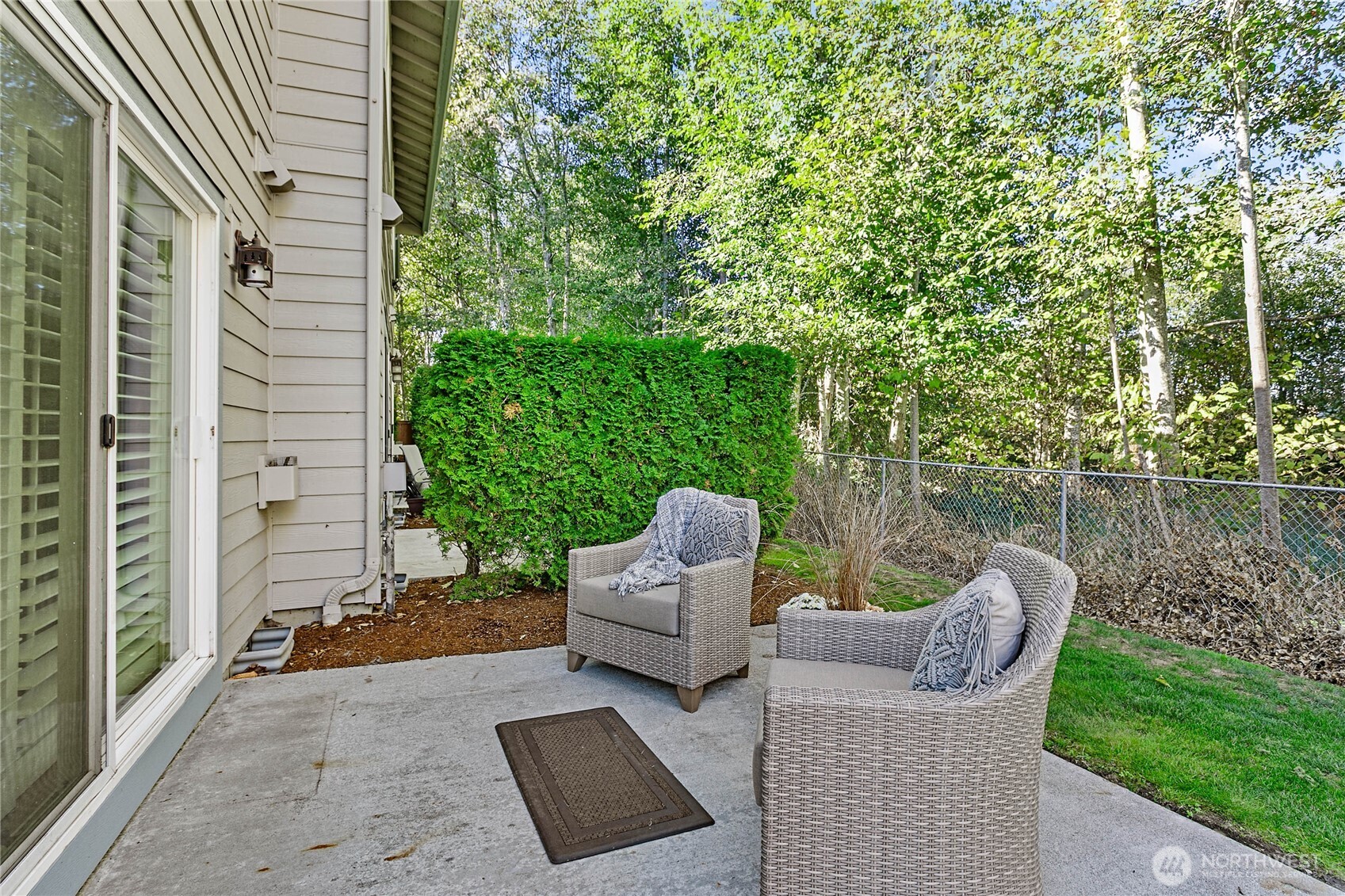 1384 Bayview Court, Unit E1 Blaine, WA 98230 - Photo 29 of 33 a view of a patio with couches chairs and a yard