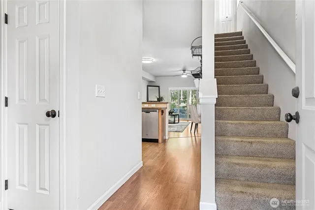 a view of a kitchen with furniture and wooden floor