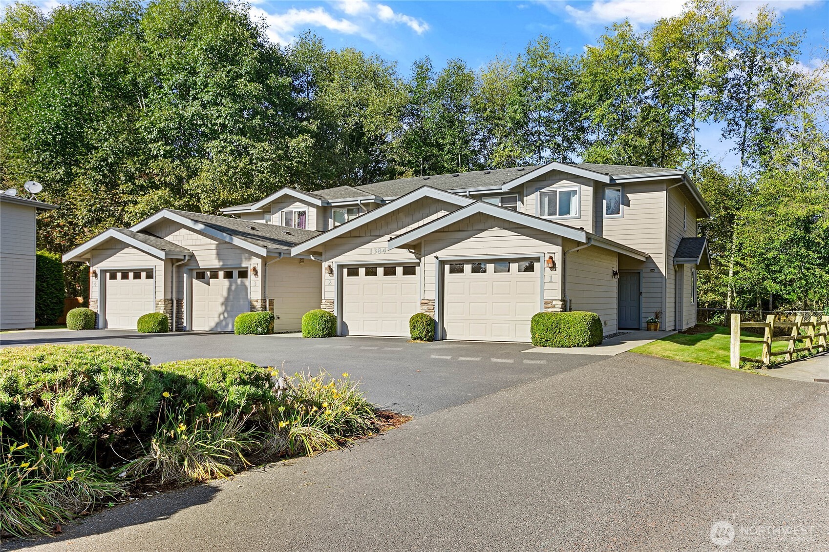 1384 Bayview Court, Unit E1 Blaine, WA 98230 - Photo 31 of 33 a front view of a house with a yard and garage