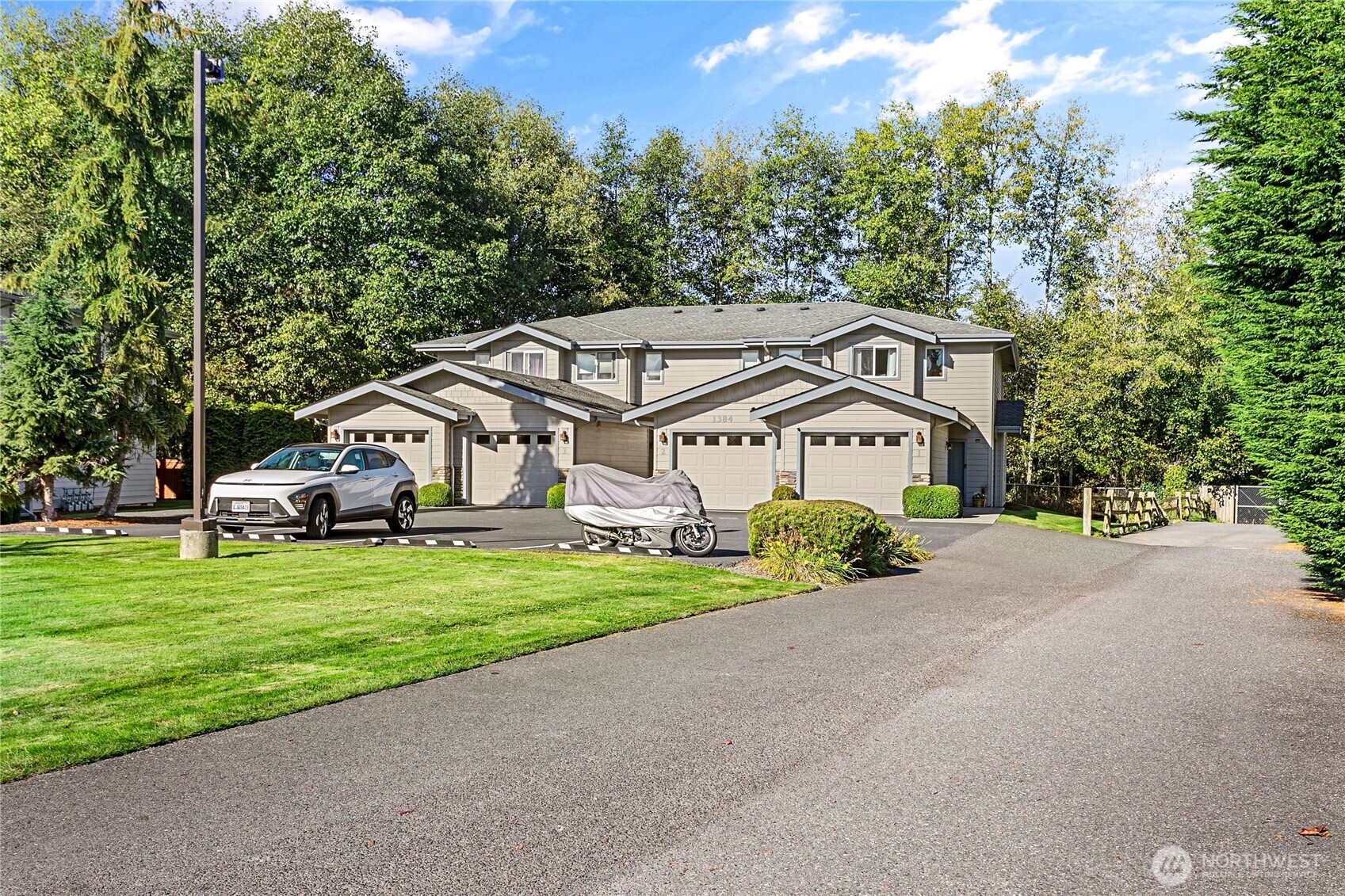 1384 Bayview Court, Unit E1 Blaine, WA 98230 - Photo 32 of 33 a car parked in front of a house with a yard