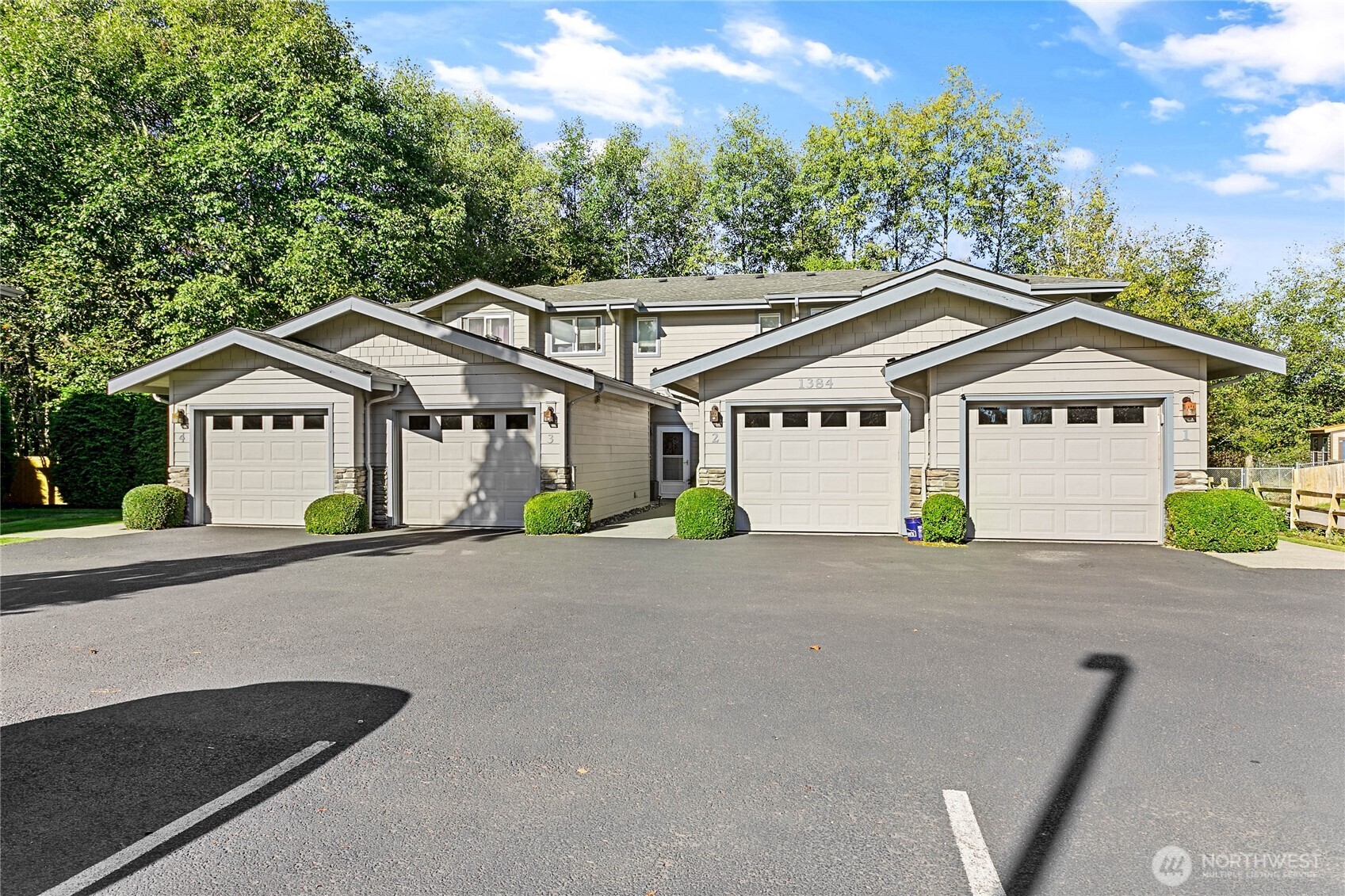 1384 Bayview Court, Unit E1 Blaine, WA 98230 - Photo 33 of 33 a front view of a house with a yard and garage