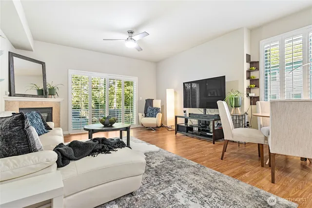 a living room with furniture large window and a flat screen tv