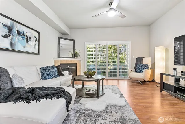 a living room with furniture large window and a table