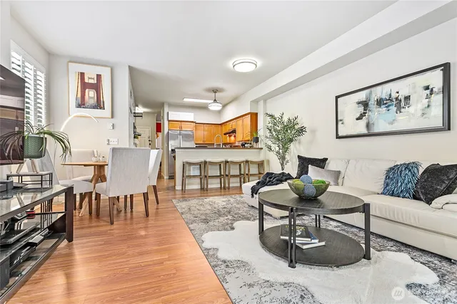 a living room with furniture a rug and a large window