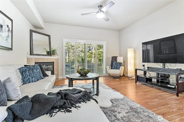 a living room with furniture large window and a flat screen tv