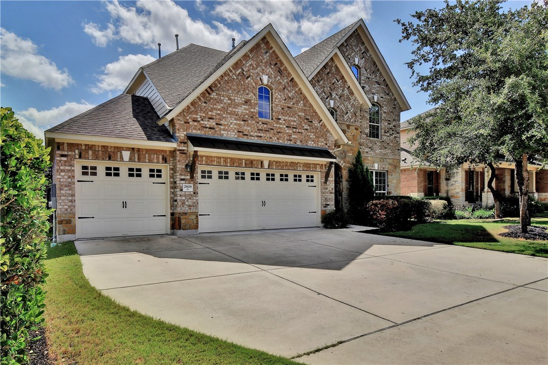 a view of a house with a yard and potted plants