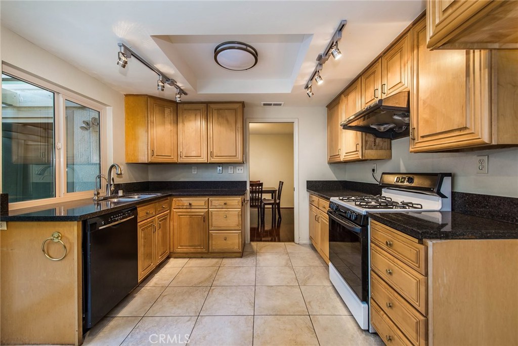 43 Morena Irvine, CA 92612 - Photo 15 of 42 a kitchen with stainless steel appliances granite countertop a stove a sink and a microwave