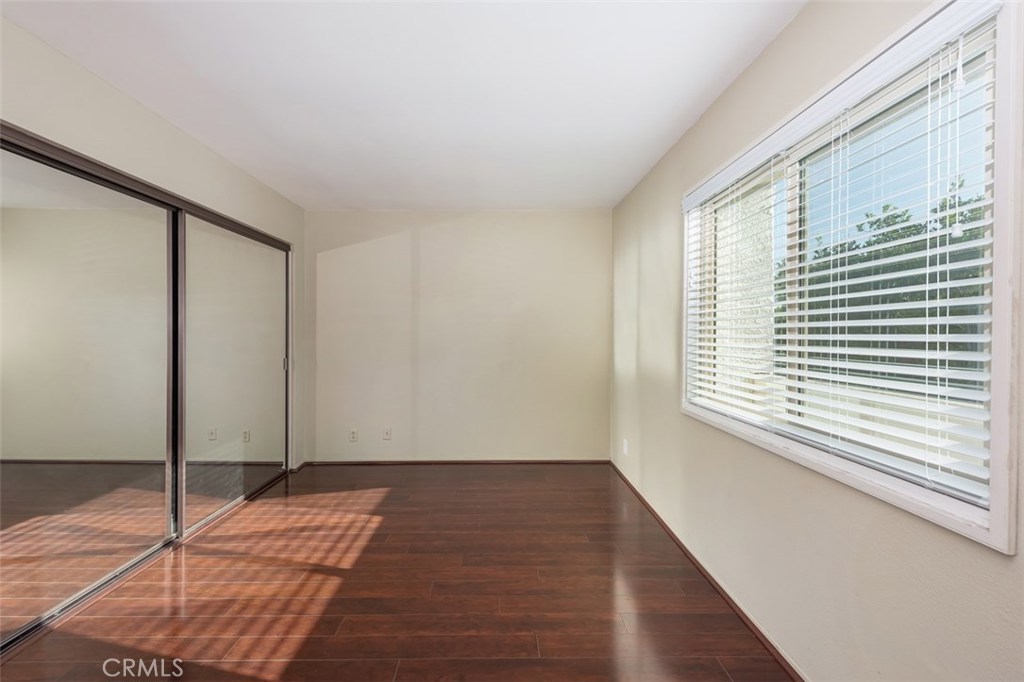43 Morena Irvine, CA 92612 - Photo 30 of 42 a view of an empty room with window a ceiling fan and wooden floor
