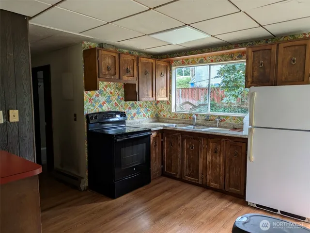 a kitchen with stainless steel appliances granite countertop a refrigerator and a sink